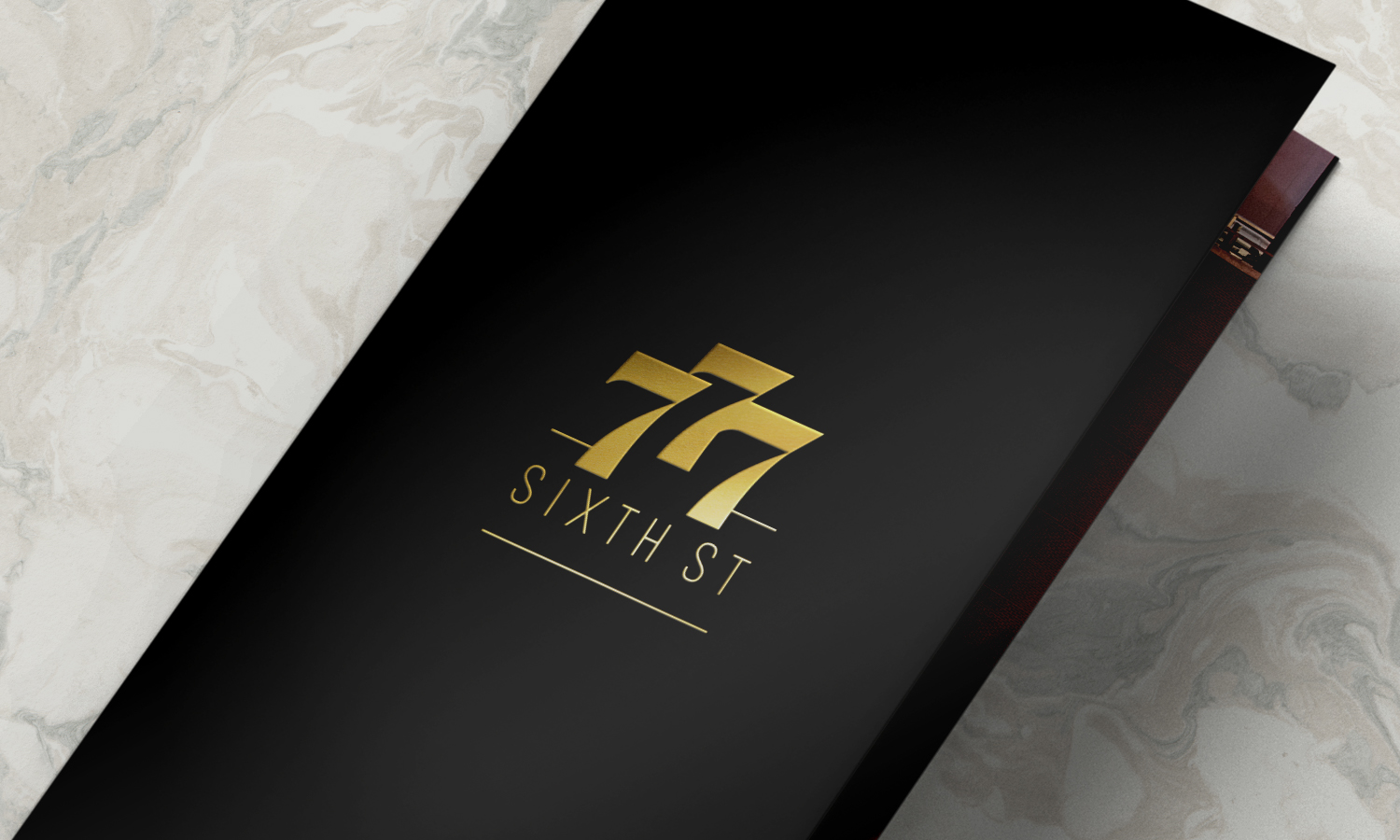 777 Sixth high-impact brochure: front face with logo in gold foil