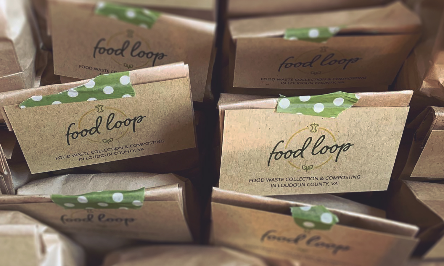 Rows of Food Loop cards on promotional paper bags of compost soil